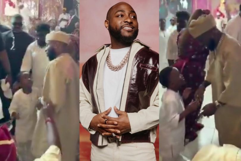 Between Davido and a young fan at an event