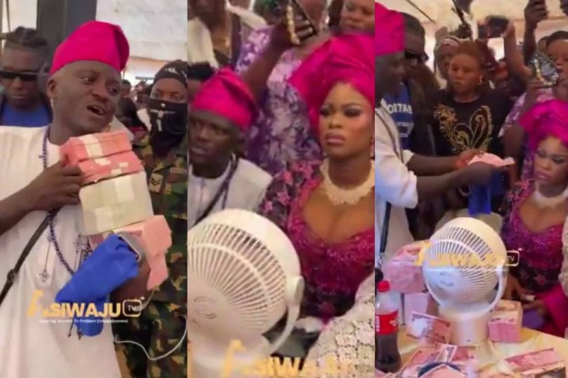 Portable rains bundle of cash on wife at naming ceremony