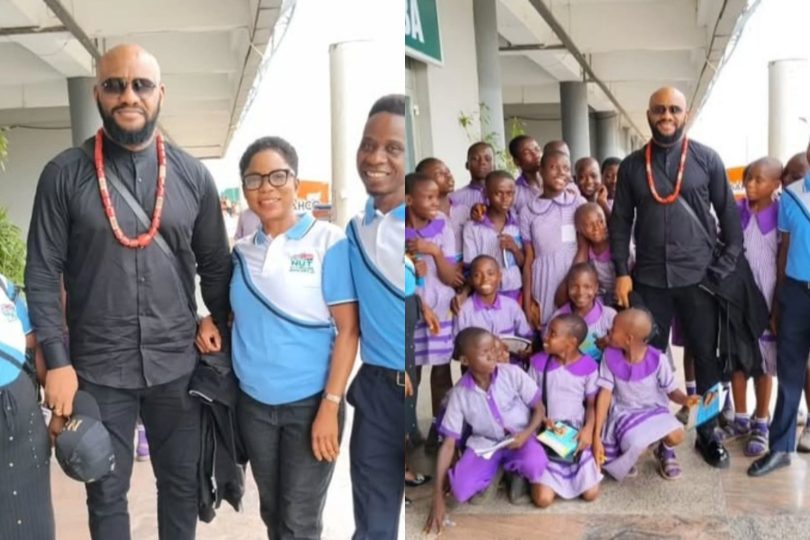 Yul Edochie with school students and teachers at airport